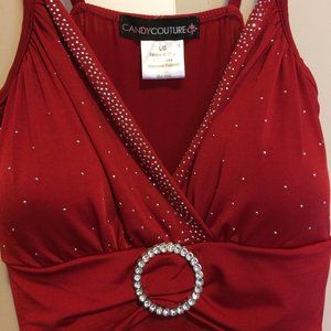Ladies, red, low cut, sleeveless top, full of sparkles and crystal clasp.